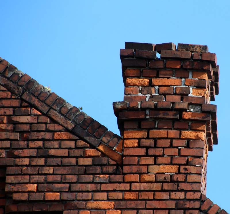Signs Your Tinley Park Home Needs a Chimney Inspection Damaged chimney on an Tinley Park home showing cracks and missing mortar